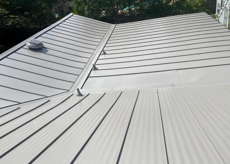 Solar attic fan installed on a metal roof for Roof Ventilation in Orangetown